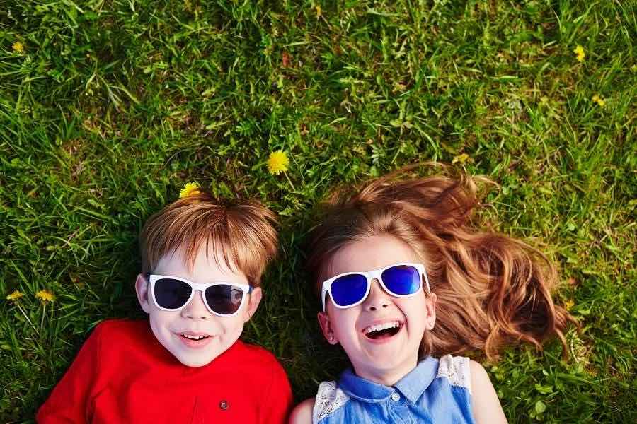 Two children with sunglasses ready for a bright future